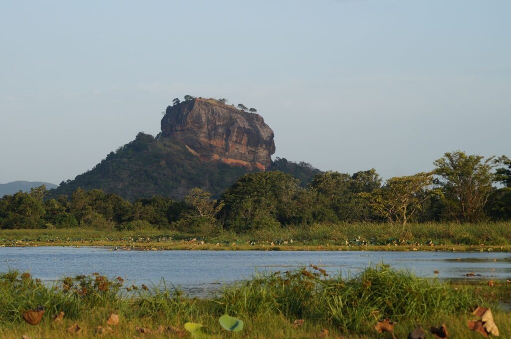 Sigiriya rock rising above the surrounding forest