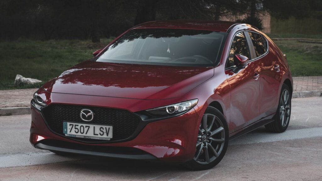A small red hatchback photographed from the front