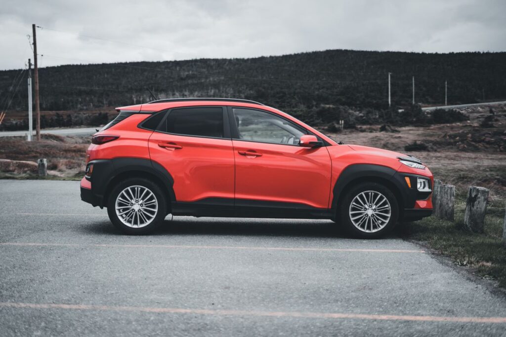 A red compact crossover photographed from the side